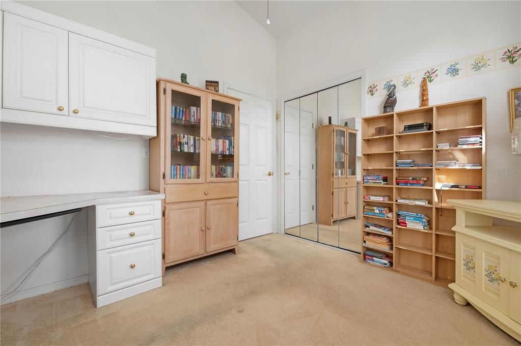 Bedroom 2 with bookcases and mirrored closet