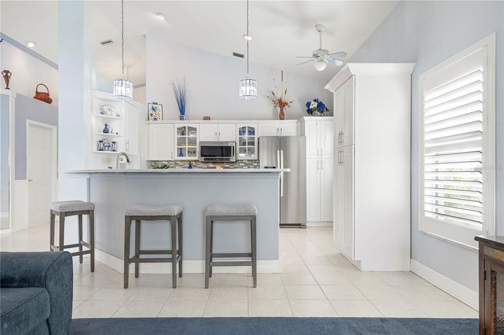 Kitchen showing bar and barstools