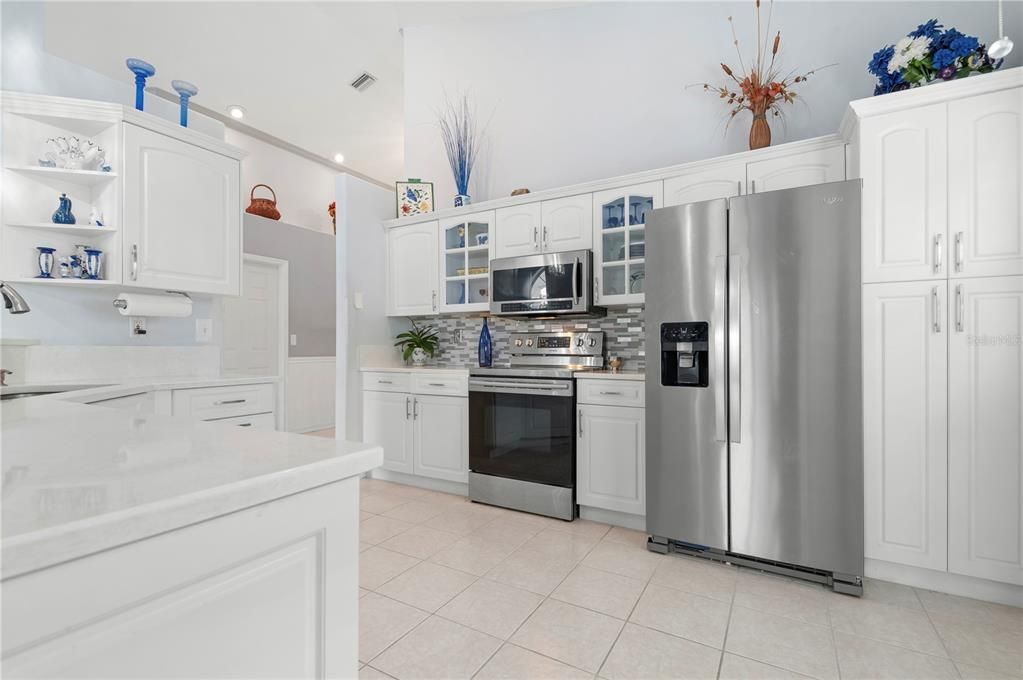 Kitchen with range and refrigerator