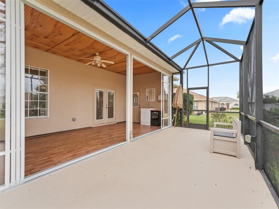 Birdcaged back patio w/access to backyard