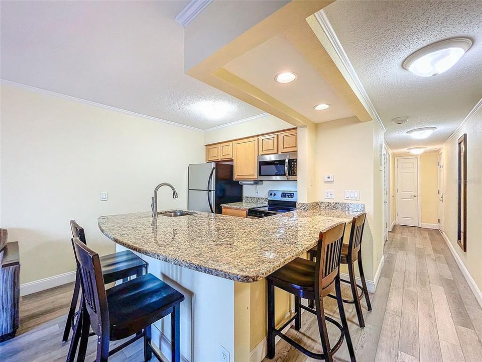 Foyer, upgraded wrap around granite countertop, seating for four +