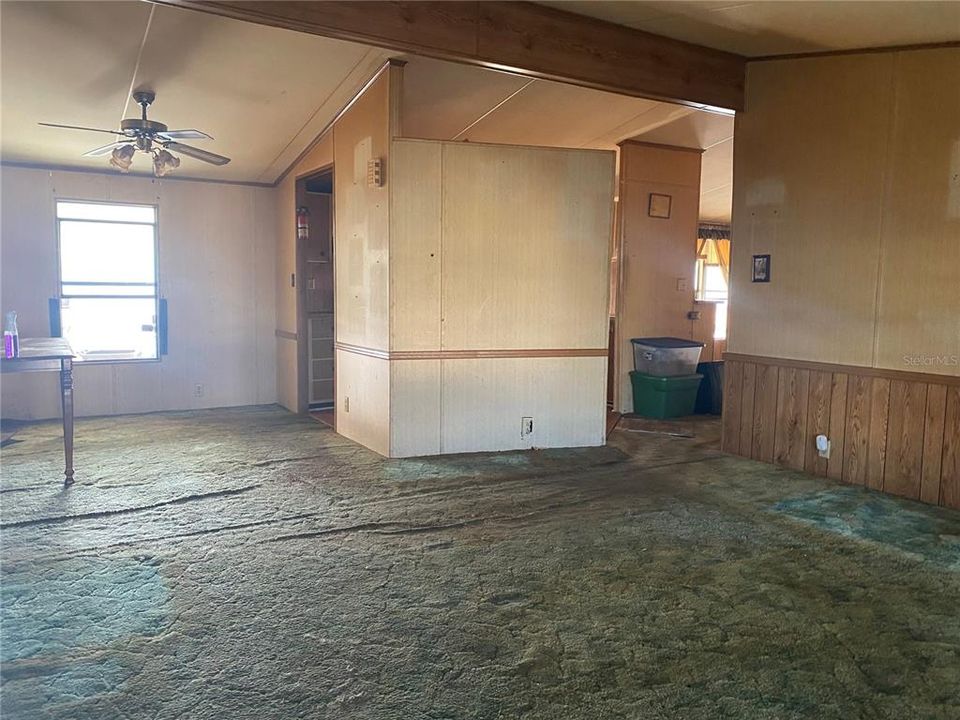 Living room - dining room area.  Kitchen is behind the wall