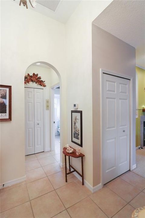 Foyer coat closet and hall to guest suite