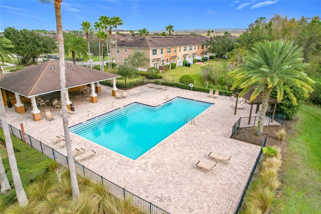 A view of the community pool looking toward the covered area, which would be great for having lunch or a birthday party.