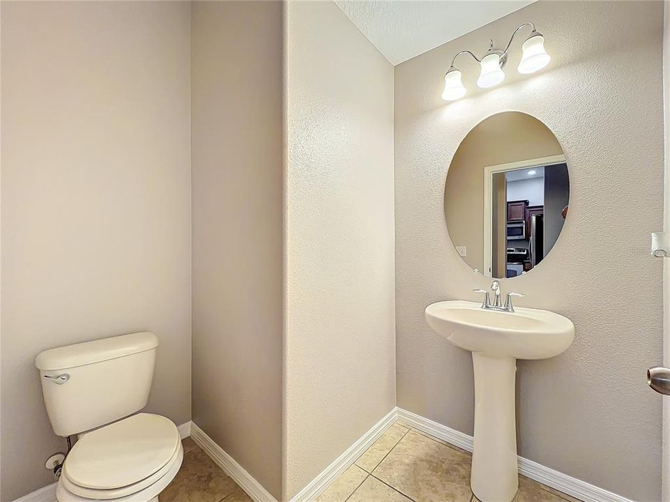 The guest bathroom has a pedastal sink.