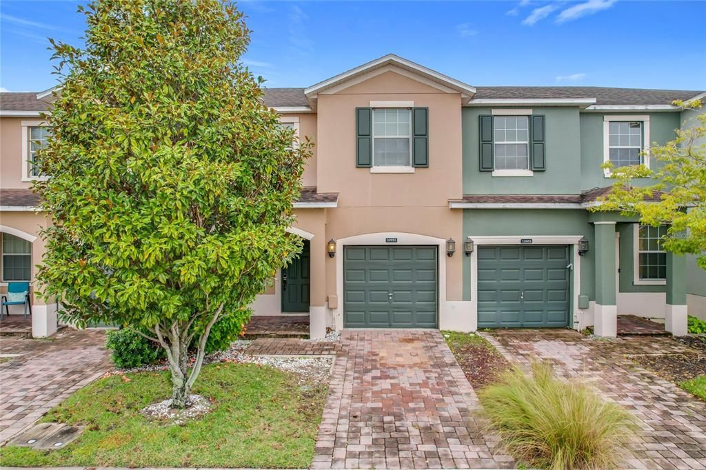 The brick paver driveway will lead you to the one-car garage.