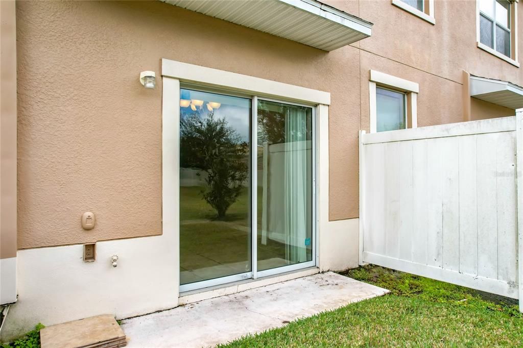 A view of the sliding glass door taking you to the inside of the townhome.