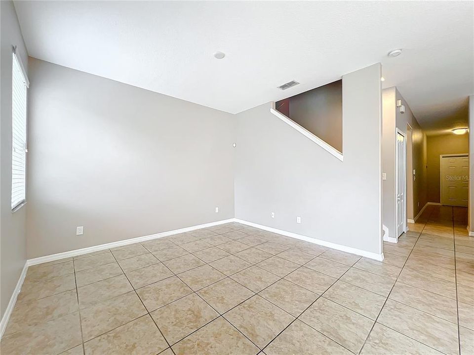 Looking from the sliding glass door to the front door.  The first floor has ceramic tile flooring, which makes for easy cleanup.