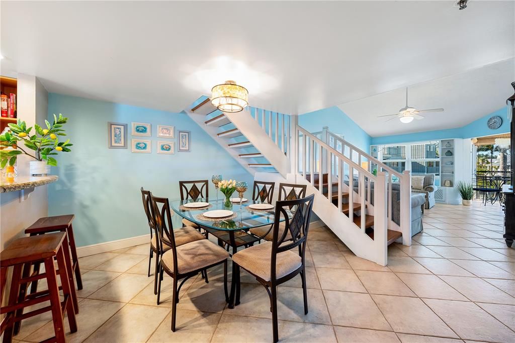 Dining room area, with kitchen breakfast bar on the left, and living room to the right.