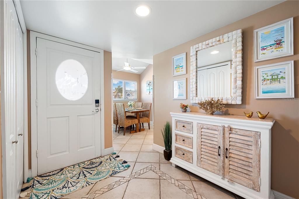 Interior front entry, leading to dinette & kitchen area on the right. To the left is the coat closet and entrance to ground-floor full bathroom.