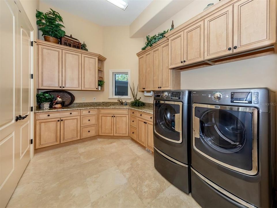 Laundry room with sink and storage room