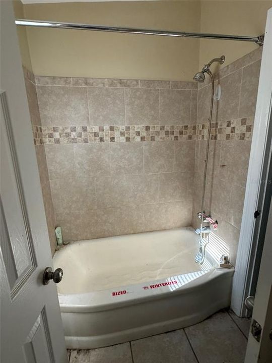 tub with shower curtain in separate room