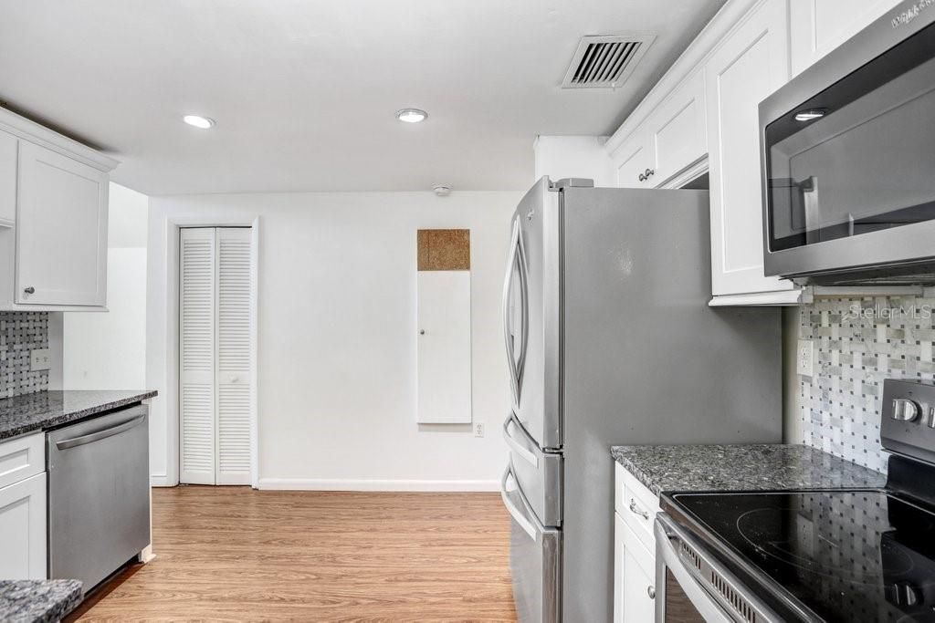 Kitchen with new back splash, granite, cabinets and stainless steel appliances