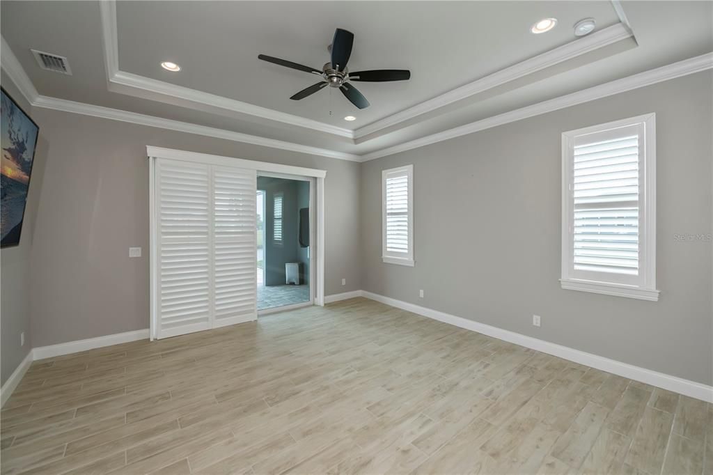 Master suite with slider access to the pool! Plantation shutters galore!