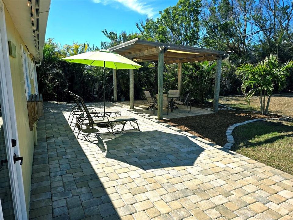 Gorgeous pavered outdoor living area with private shower.