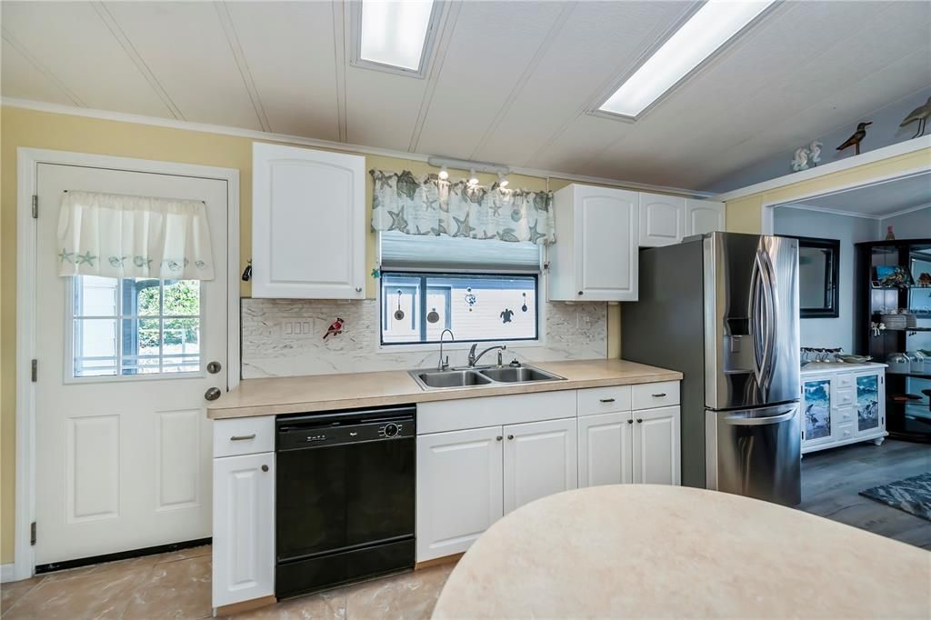 Kitchen showcasing updated appliances and backsplash