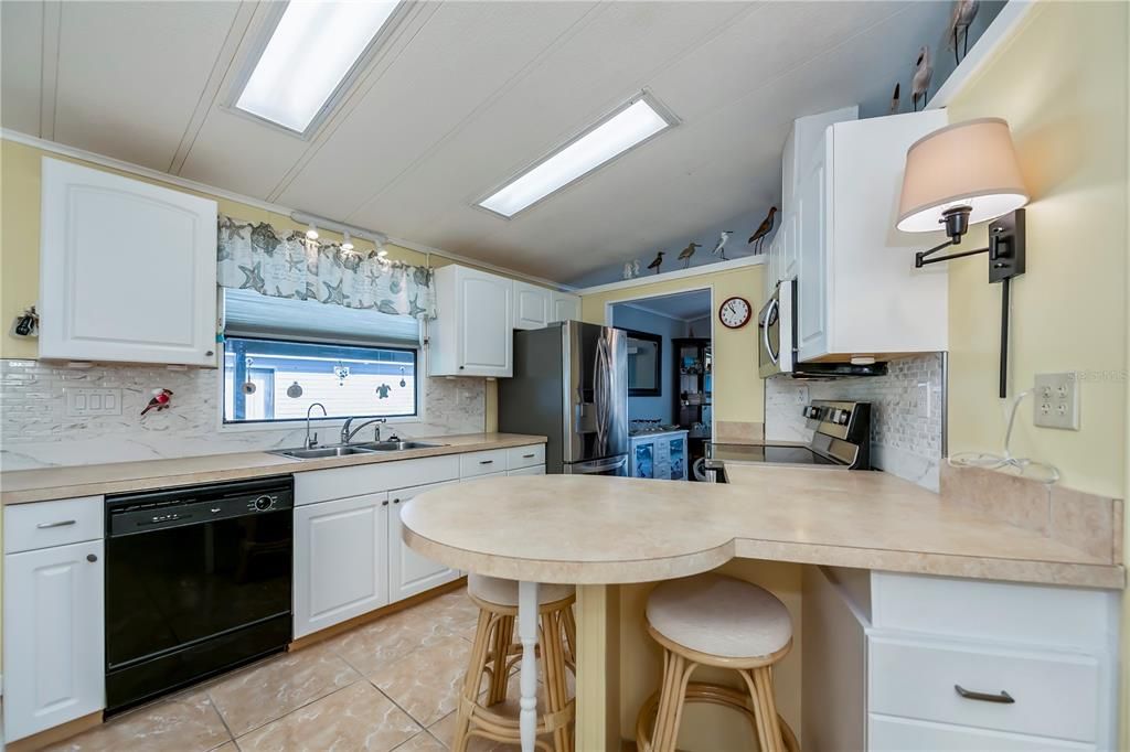 Kitchen showcasing updated appliances and backsplash