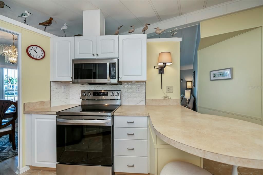 Kitchen showcasing updated appliances and backsplash