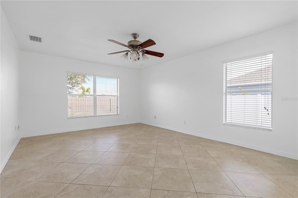 Large, bright main bedroom with tiled floor