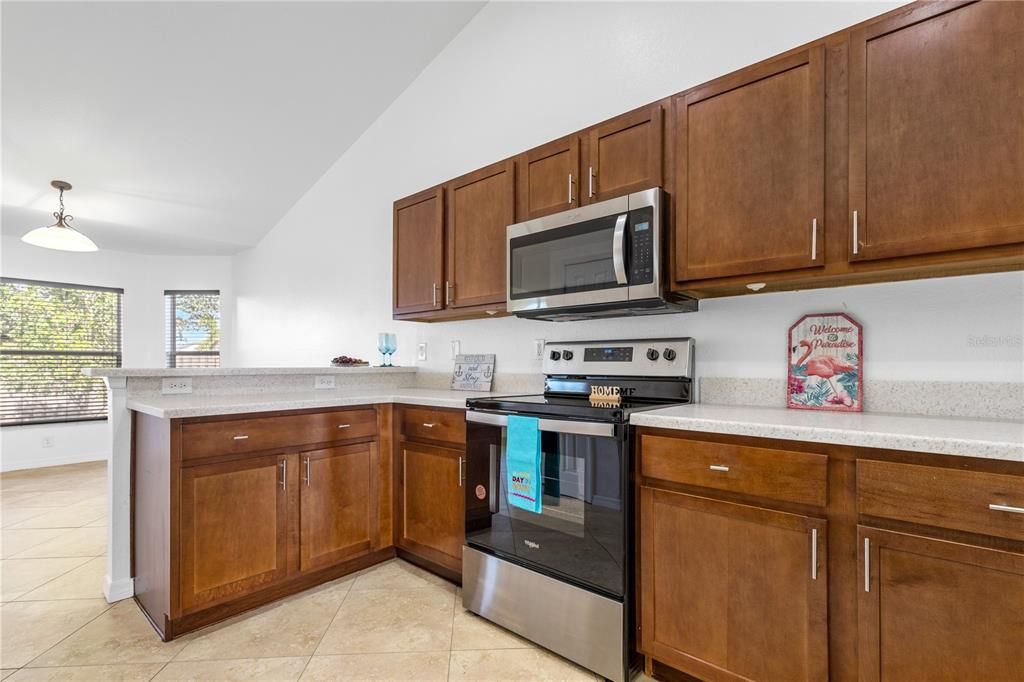 Spacious kitchen with new countertop and stainless appliances