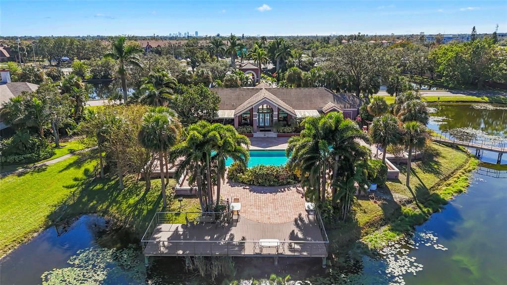 Clubhouse with one of the pools and spa. There is a deck to sit and enjoy the view.