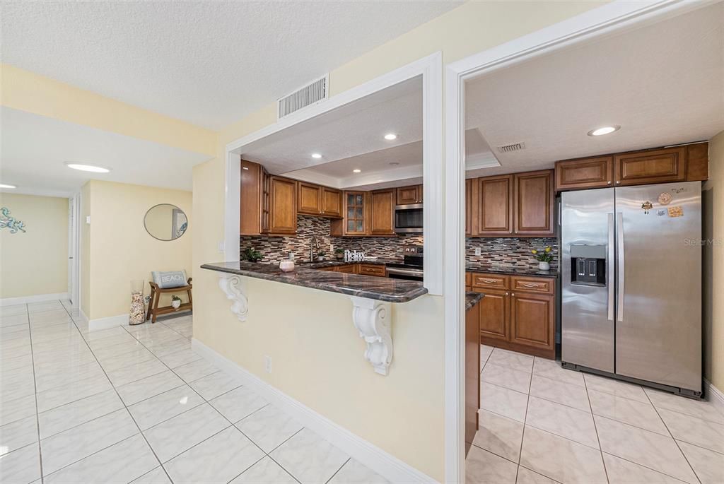 kitchen passthrough connecting with dining room. High top counter can fit 3 people comfortably.