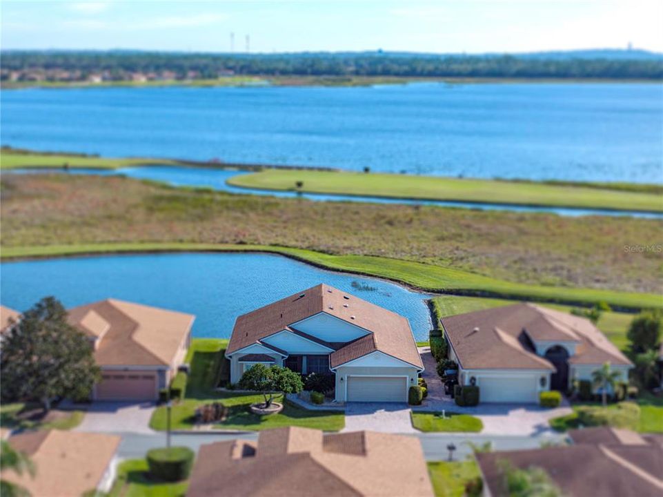 Drone view of home, pond, golf course & Lake Ashton