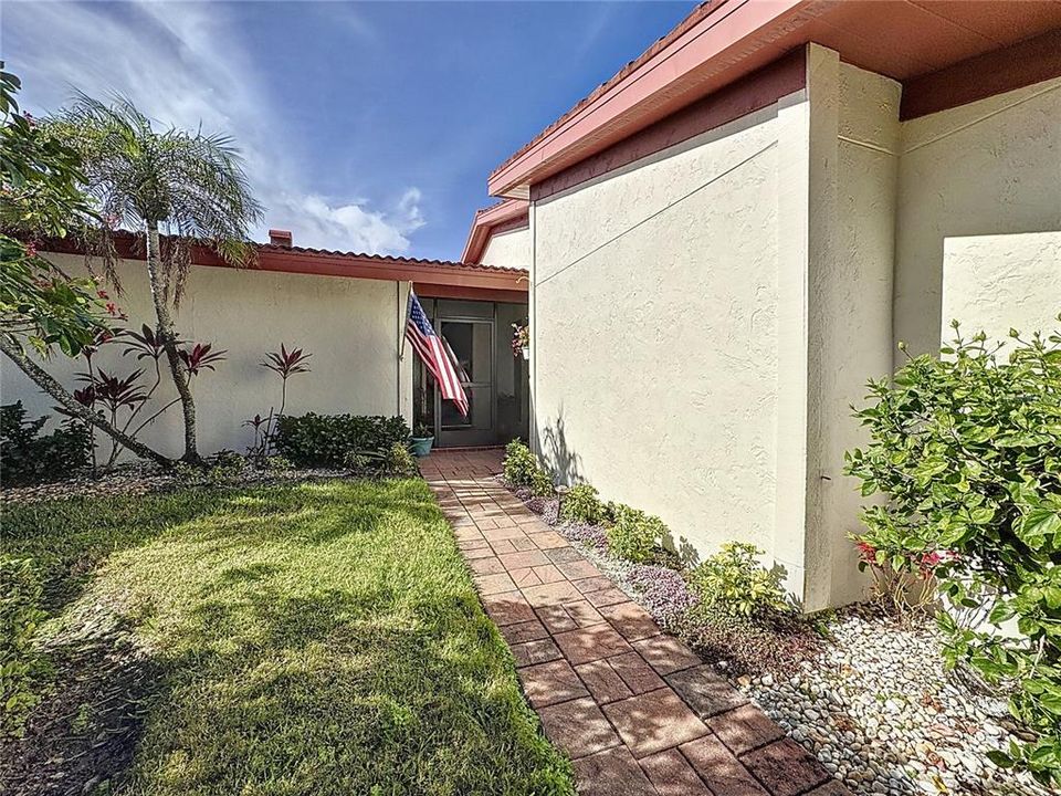 WALKWAY TO FRONT DOOR LINED W/ FLOWERS