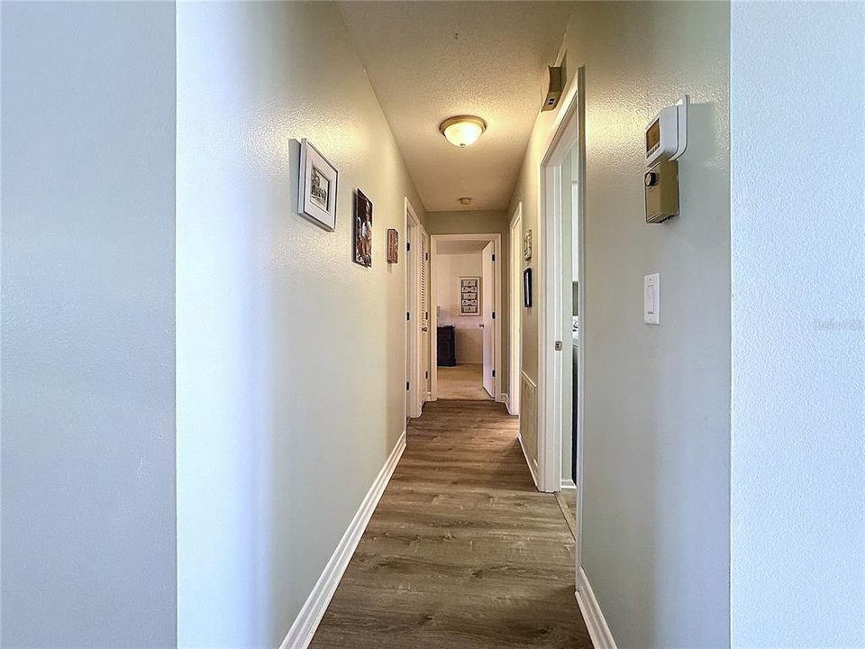 HALLWAY TO BEDROOMS W/ VINYL FLOORING