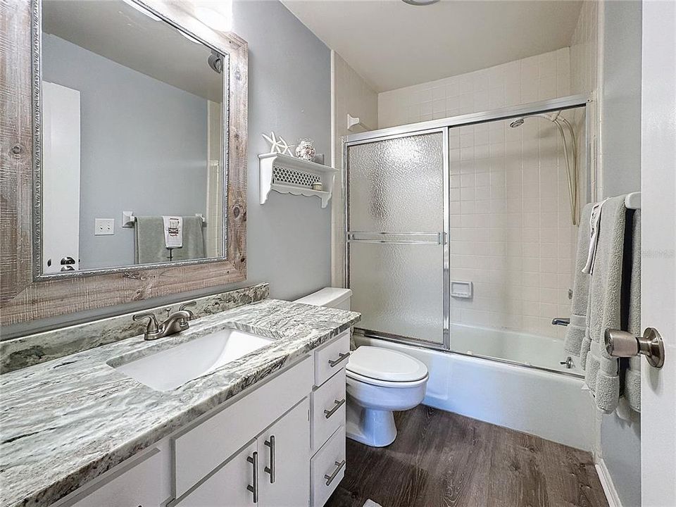 BATH 2 W/ GRANITE, VINYL FLOORING AND TUB/SHOWER