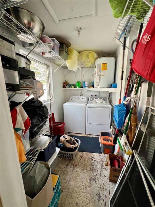 Laundry area with storage in carport