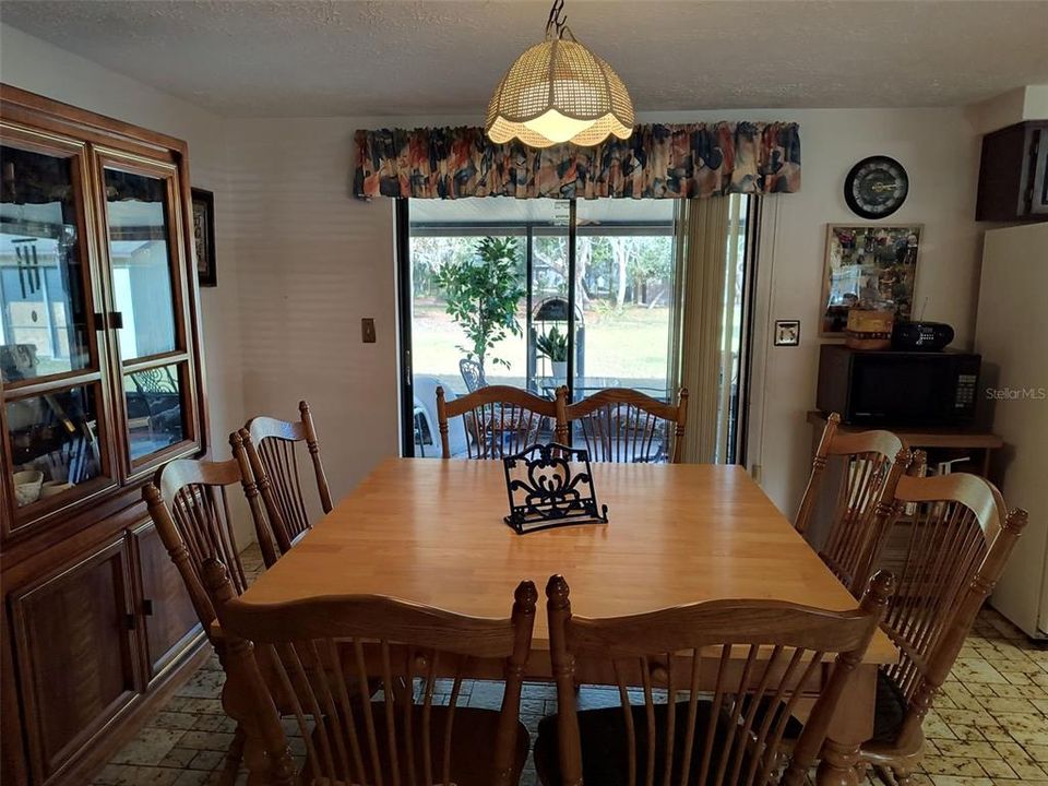 Dining overlooks screen porch back yard