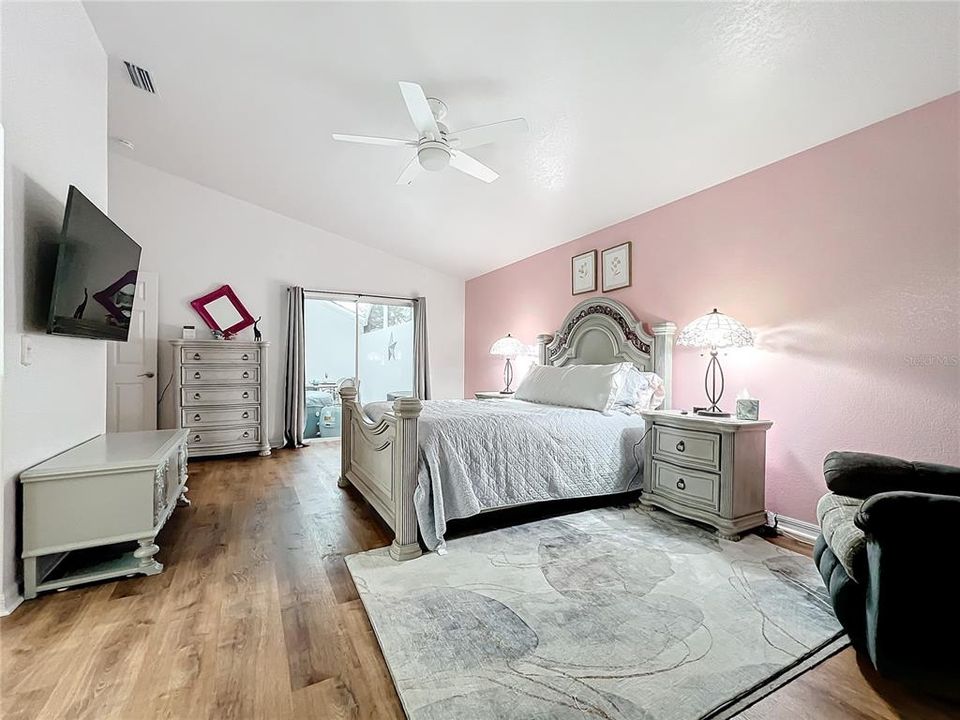 The primary bedroom has sliding glass doors that open to the courtyard.