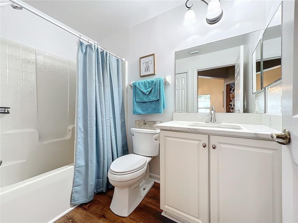 Guest bathroom #2 has been updated with a high counter and quartz countertop, new sink, faucet and toilet