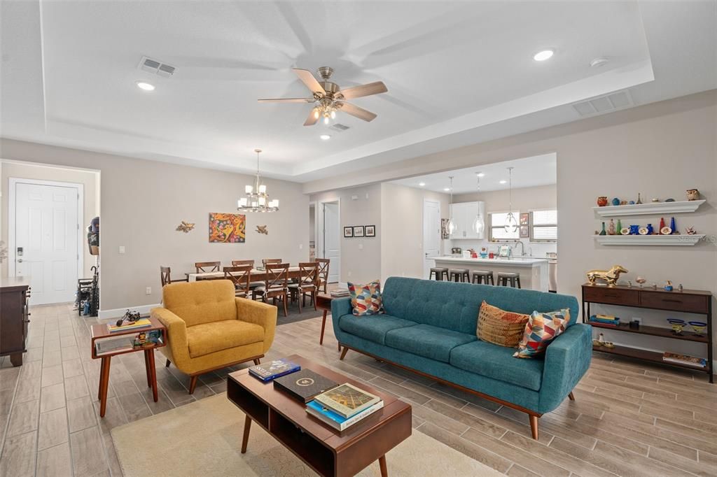 Views of the Family Room, Dining Room, Kitchen and Foyer. he Main Living Areas are tiled with a Wood Look Plank Ceramic Tile.