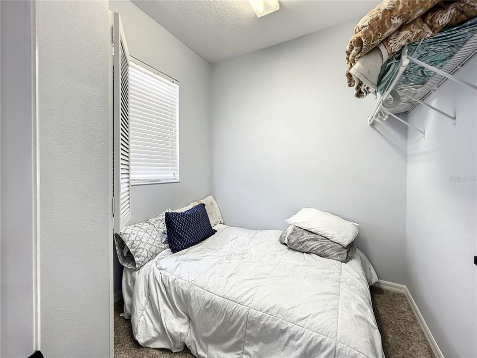 Walk-in closet being used for bed