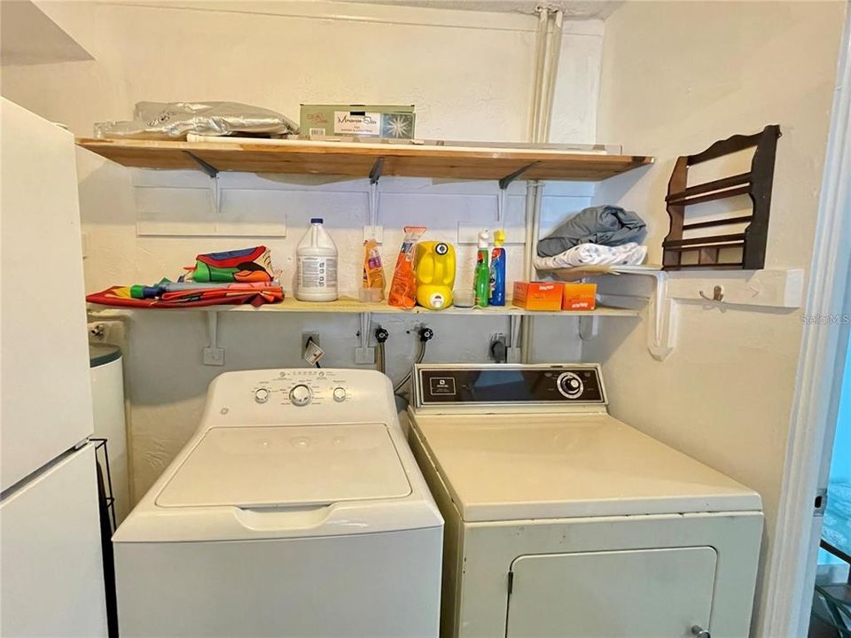 laundry room with fridge, washer and dryer