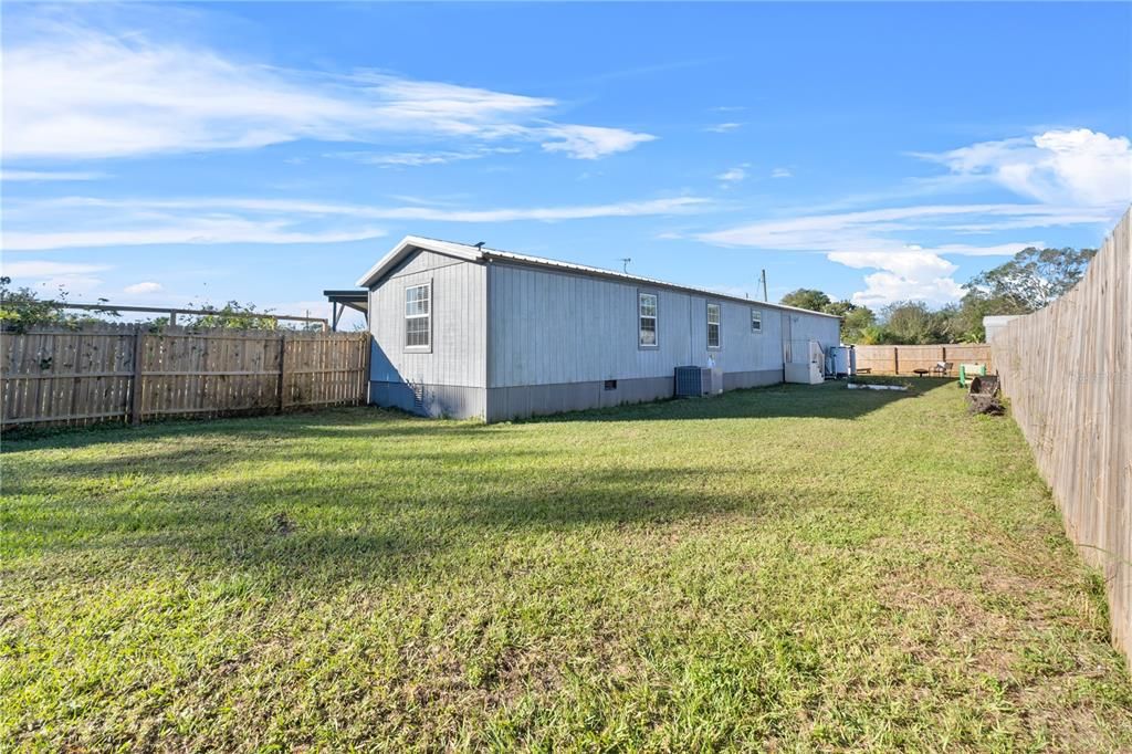 Back of the house with private wooden fence