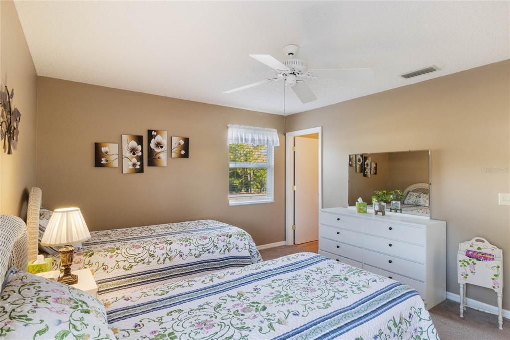 Primary Bedroom offers a Walk in Closet and Wall to Wall Carpeting