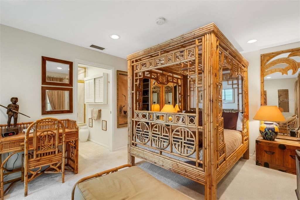 primary bedroom with walk-in closet and bathroom with steam shower