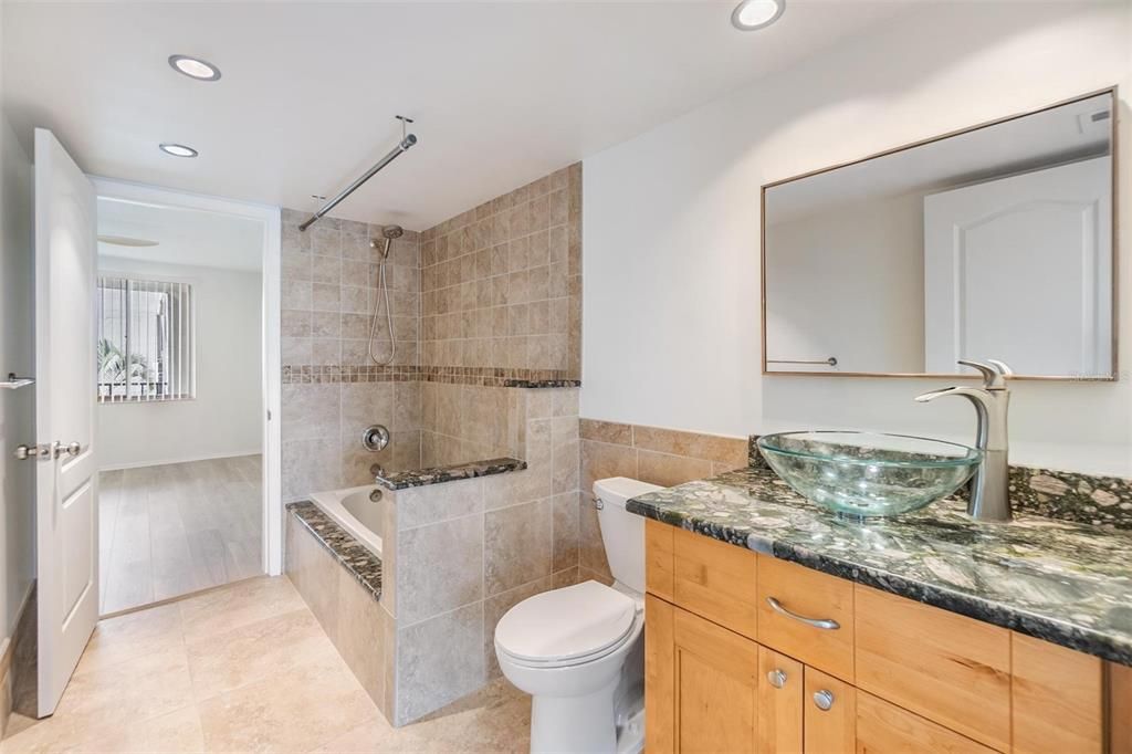 Guest/second bathroom remodeled with stylish vanity, beautiful tile surround bath/shower combo and large medicine cabinet.