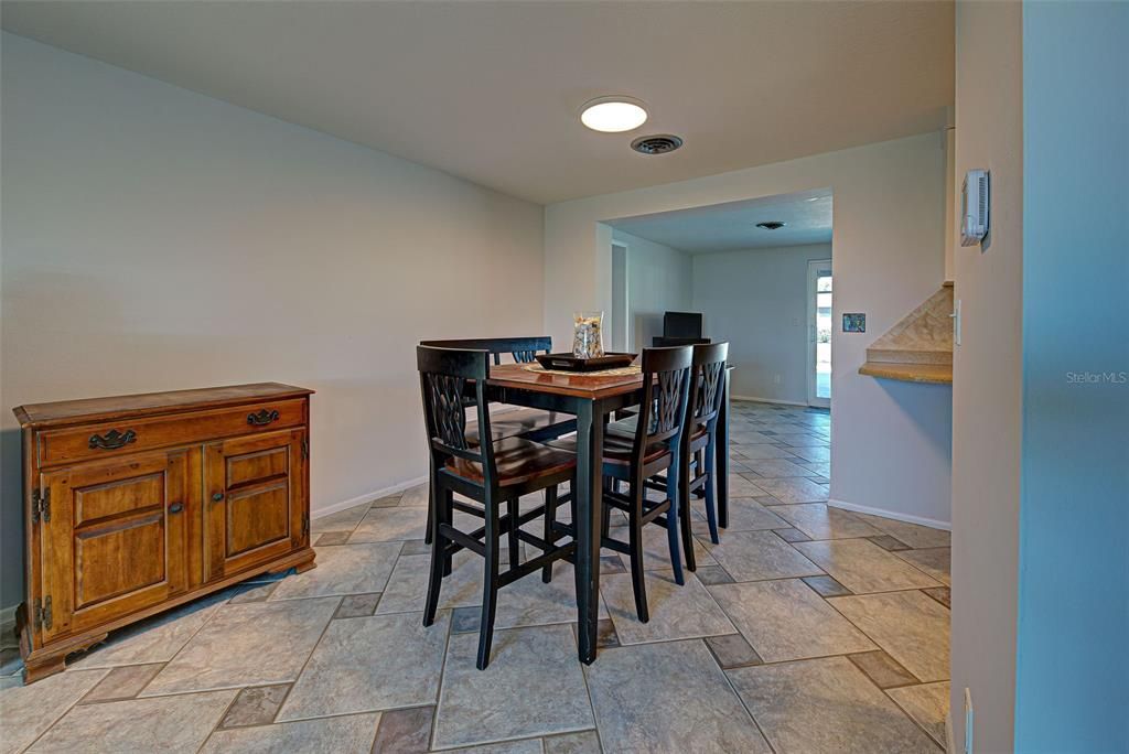 The dining room is right off of the kitchen and opens up to the Florida Room and out to the pool area.