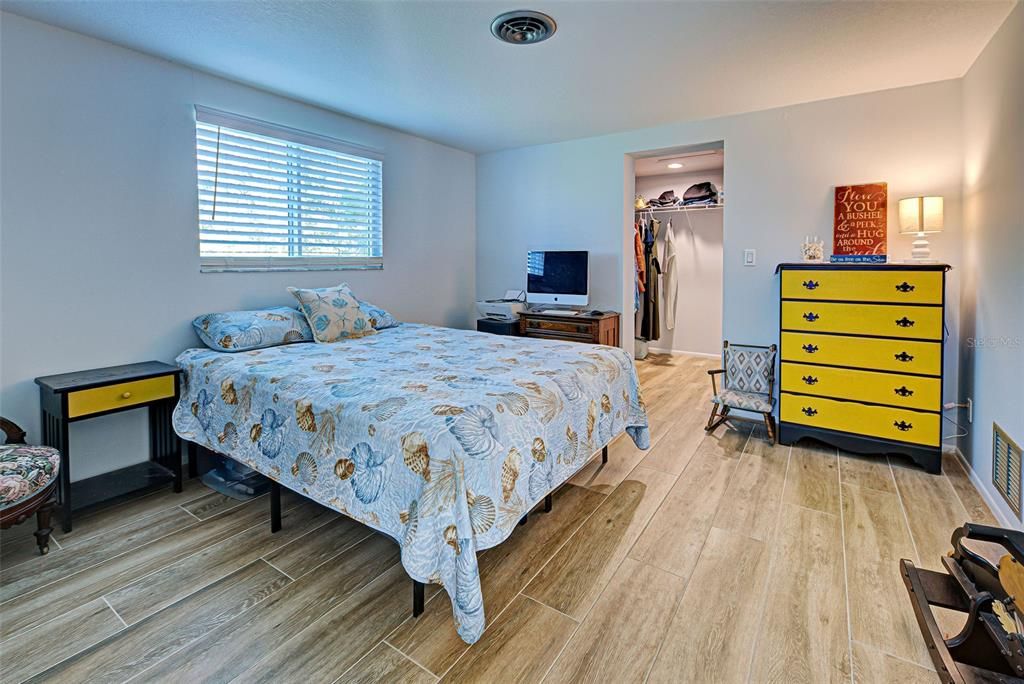 A guest bedroom with a walk-in closet.