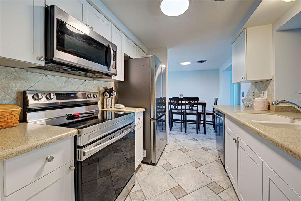 The kitchen is equipped with newer stainless-steel appliances.