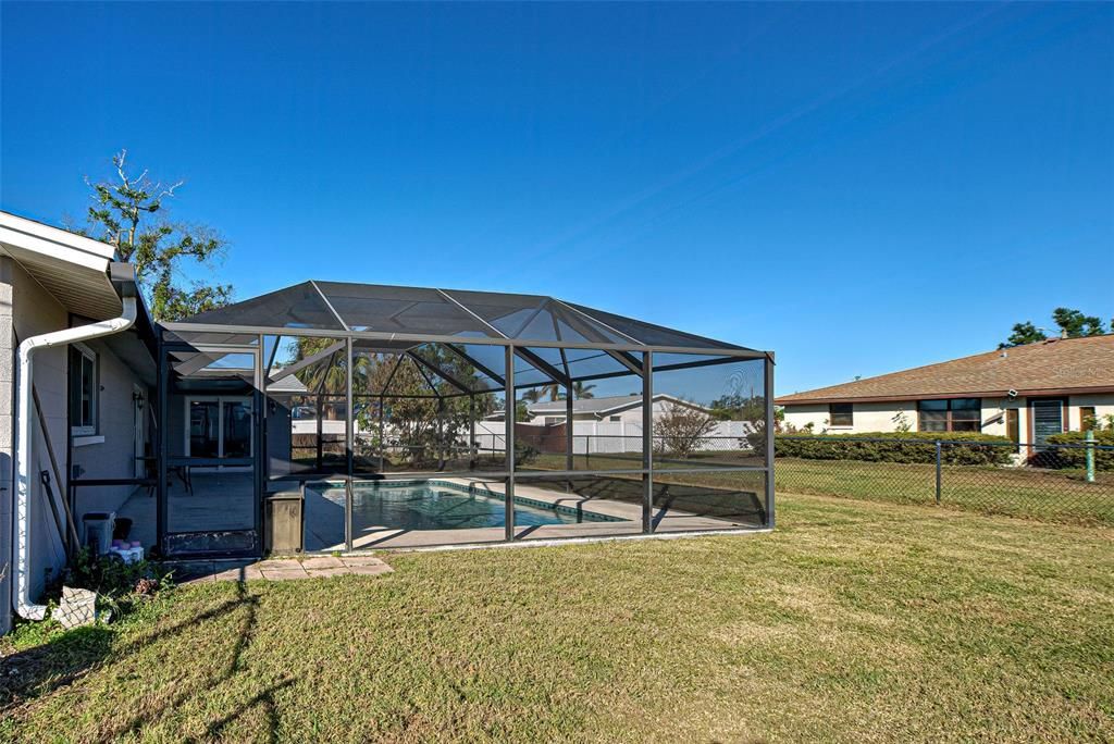 A view of the pool and the backyard.