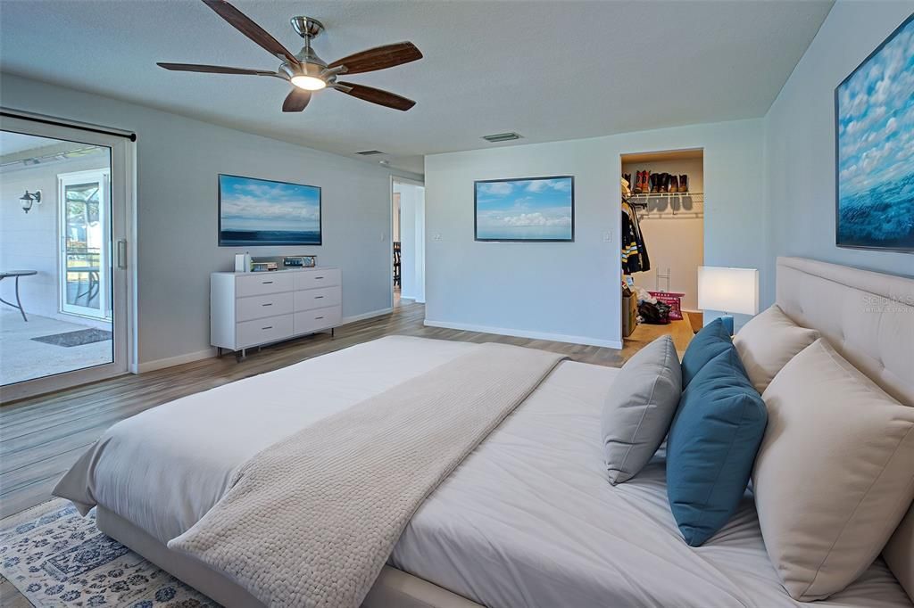 Virtually staged.  The bedroom has sliding glass doors out to the pool area.