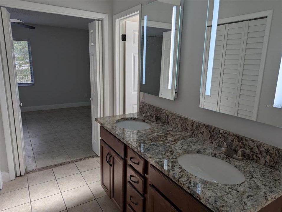 Primary bath with view of the bedroom