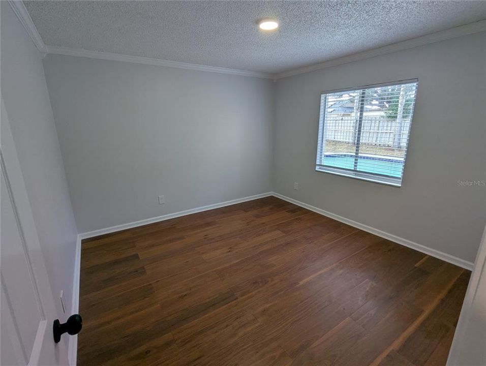 Bedroom 4 with view of the pool