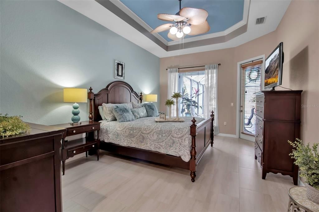 Primary bedroom with door to pool and lanai