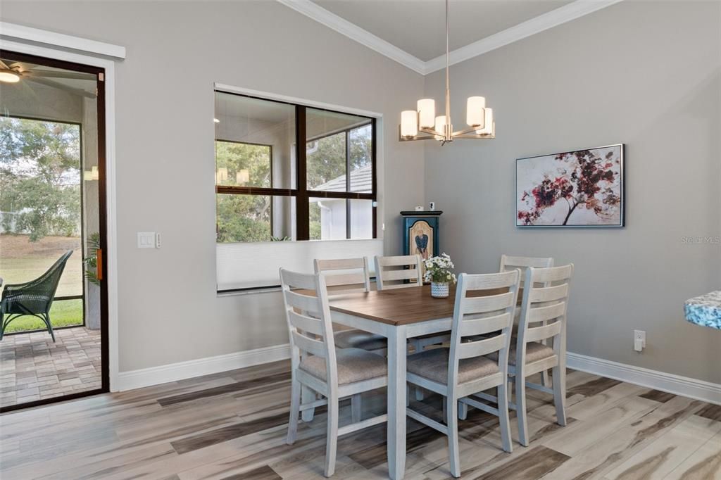 The dining area is convenient to both the kitchen and great room. Notice the silhouette blinds on the window. They are versatile and can open from the bottom up, or the top down, providing privacy and light simultaneously.